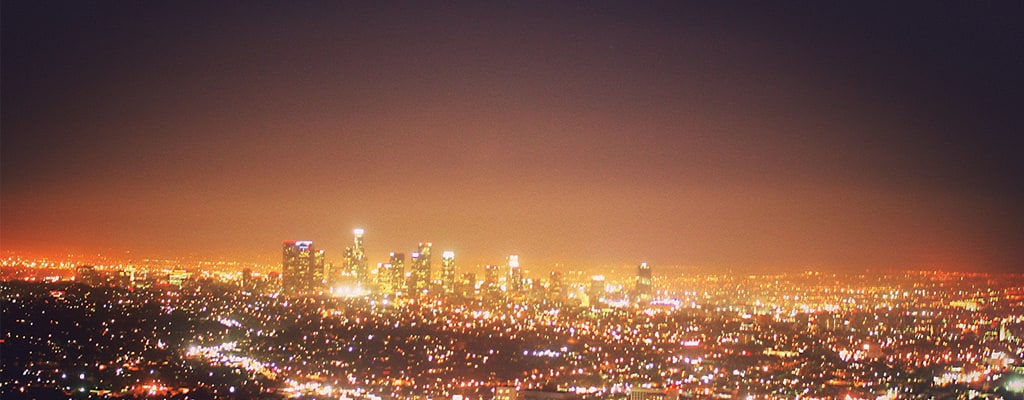 A city at night, the lights across the skyline shining brightly.