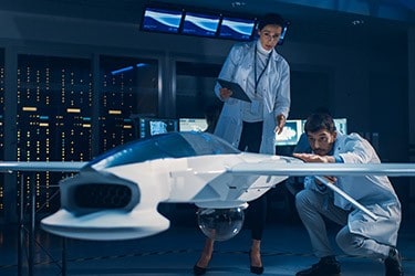 Engineers in a design studio discussing a product configuration.