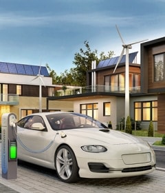Electric car parked in front of a smart home powered by renewable energy.