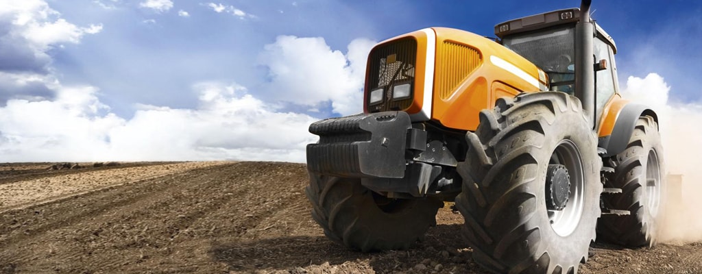 Construction vehicles operating in the field.