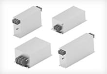 Variety of Corcom three-phase power filters on a white background